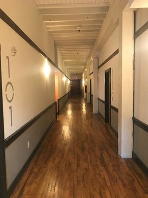 Danville apartment for rent - a hallway in a building with wood floors and white walls