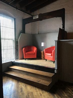 Danville apartment for rent - two red chairs in a room with a staircase