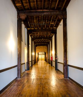 Danville apartment for rent - the long hallway of the building has a wood floor and pillars