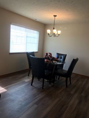 Lincoln house for rent - a dining room with a table and chairs and a window