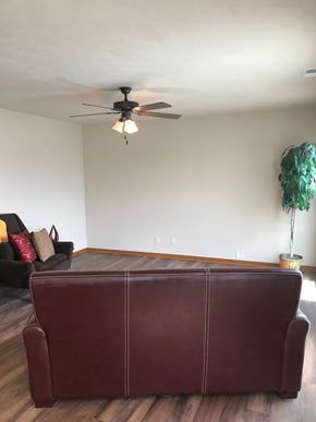 Lincoln house for rent - an empty living room with a couch and a ceiling fan