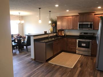 Lincoln house for rent - a kitchen with wooden cabinets and stainless steel appliances