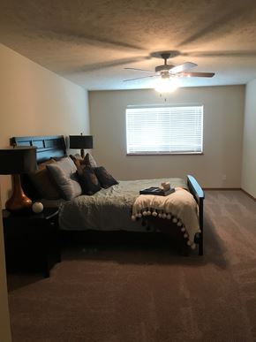 Lincoln house for rent - a bedroom with a bed and a ceiling fan