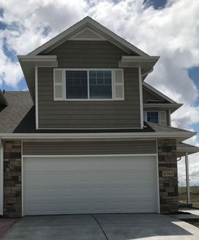 Lincoln house for rent - a home with a white garage door in front of it