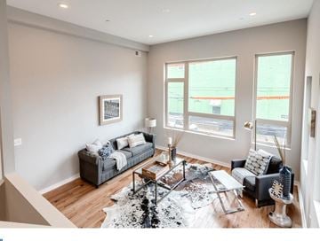 Philadelphia house for rent - A living room with a grey couch and a coffee table.