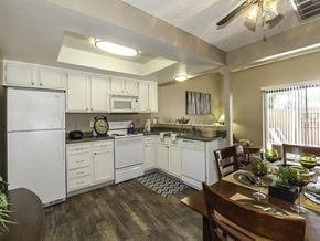 Sparks townhouse for rent - a kitchen with white appliances and a dining room table