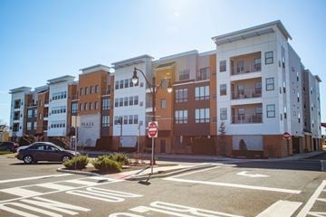 Belmar apartment for rent - A stop sign is in front of a building with a car parked in front of it.
