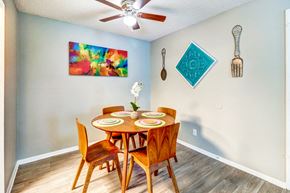 Nashville apartment for rent - a dining room with a table and chairs and a ceiling fan