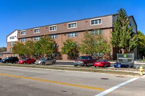 Miamisburg apartment for rent - a large brick building with cars parked in front of it