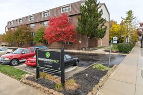 Miamisburg apartment for rent - an apartment building with a sign in front of a parking lot