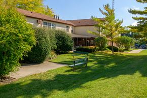 Piqua apartment for rent - a park bench in front of a building