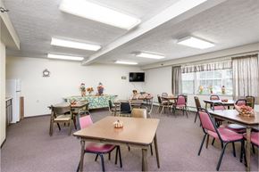 Piqua apartment for rent - a dining room with tables and chairs and a television
