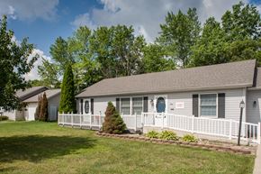 Mansfield apartment for rent - a white house with a white porch and a blue door