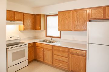 Mansfield apartment for rent - a kitchen with white appliances and wooden cabinets