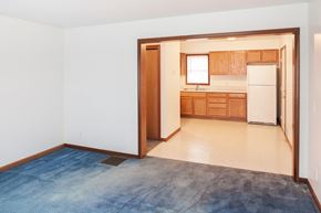 Mansfield apartment for rent - an empty living room and kitchen with a blue rug