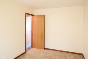 Mansfield apartment for rent - a bedroom with a door to a hallway and a carpeted floor