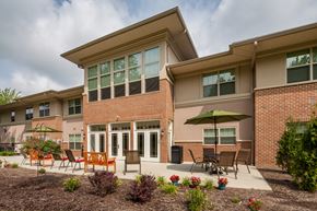 North Olmsted apartment for rent - a patio with chairs and an umbrella outside of a building