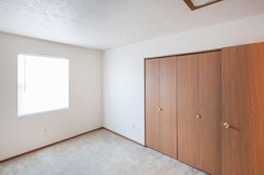 New Lebanon apartment for rent - an empty bedroom with two closets and a window