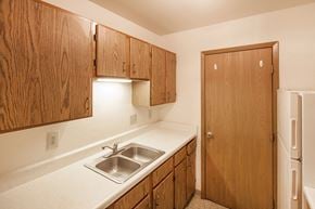 New Lebanon apartment for rent - a kitchen with a sink and cabinets and a refrigerator