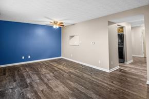 Dayton apartment for rent - a living room with blue and white walls and a ceiling fan