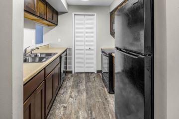 Dayton apartment for rent - the kitchen of a rental house with a refrigerator and sink
