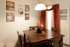 Lima apartment for rent - a dining room table with a vase of flowers on it