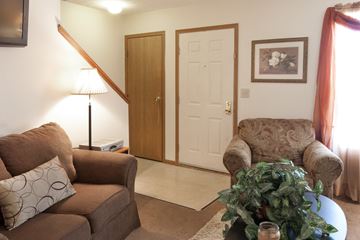 Lima apartment for rent - a living room with two couches and a table with a plant