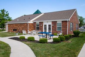 Hilliard apartment for rent - a patio in front of a building with a table and chairs
