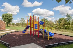 Fostoria apartment for rent - a playground with a blue and yellow playset in a park