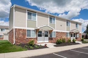Fostoria apartment for rent - an exterior view of an apartment building with a sidewalk