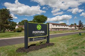 Fostoria apartment for rent - a sign for fossilia townhouses on the side of a road