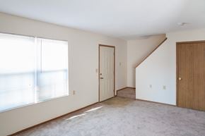 Marysville townhouse for rent - an empty living room with a large window and a door