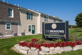 Marysville townhouse for rent - the meadows apartments sign in front of a building