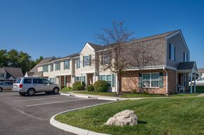 Marysville townhouse for rent - a parking lot in front of an apartment building with a van parked in the driveway