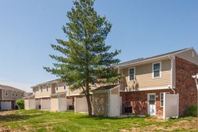 Eminence apartment for rent - an apartment building with a tree in front of it