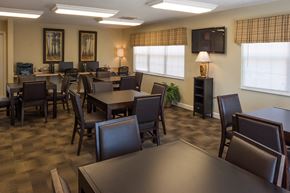 Eminence apartment for rent - a dining room with tables and chairs and a television