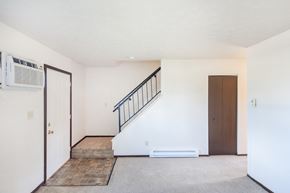 Fostoria apartment for rent - an empty living room with a staircase and a door