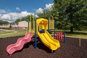 Fostoria apartment for rent - a playground with a yellow slide and a pink slide