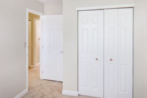 Lawrenceburg apartment for rent - a bedroom with two closets and a door to a hallway