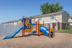 Lawrenceburg apartment for rent - a playground with a blue and yellow play set in front of a house