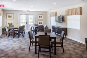 Lawrenceburg apartment for rent - a dining room with a table and chairs and a television