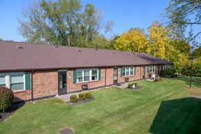 Englewood apartment for rent - the front of a brick house with a lawn and trees