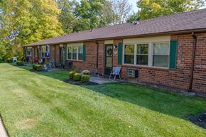 Englewood apartment for rent - a brick house with green shutters and a lawn