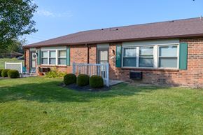 Englewood apartment for rent - a brick house with green shutters and a lawn