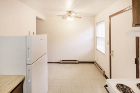 Cambridge apartment for rent - a kitchen with white appliances and a refrigerator  and a door to a room