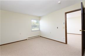 West Milton apartment for rent - a bedroom with white walls and carpet and a door open