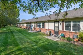 West Milton apartment for rent - a row of houses with grass and trees in front of them