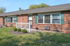 West Milton apartment for rent - a brick house with green shutters and a porch