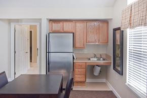 Washington Court House apartment for rent - a kitchen with a stainless steel refrigerator and a table and chairs