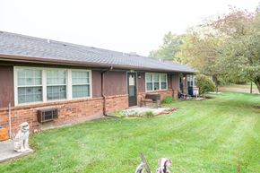 Mechanicsburg apartment for rent - a dog standing in the yard in front of a house